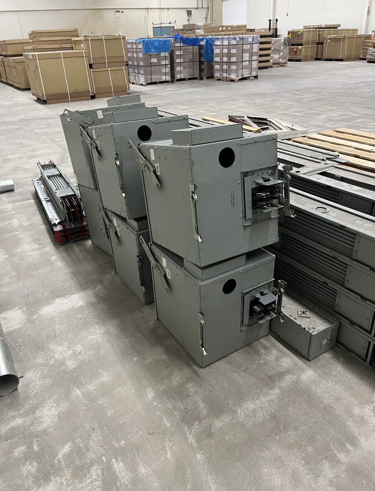Bus duct straight lengths and tap boxes staged in the warehouse after an electrical equipment purchase